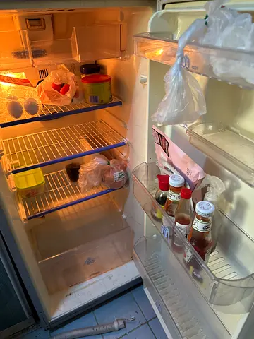 Used silver double-door refrigerator in working condition