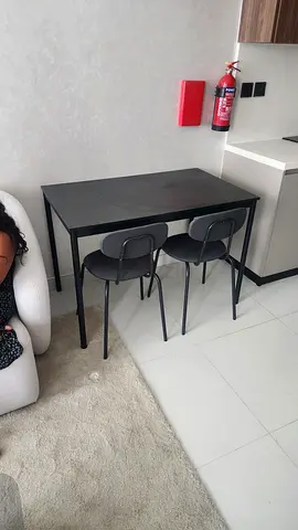 Compact black dining table with two matching chairs - good condition