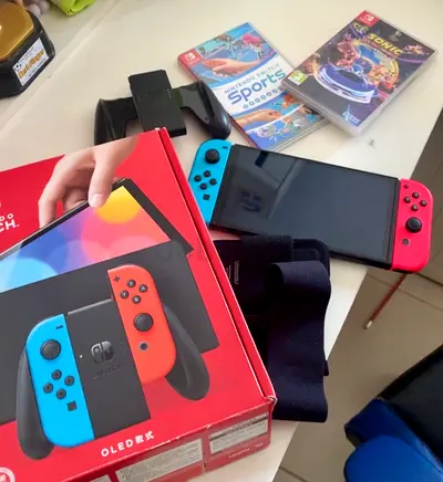 Nintendo Switch OLED with Neon Blue/Red Joy‑Cons + 2 Games and Accessories
