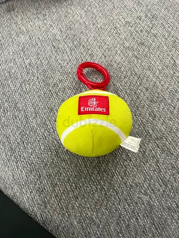 Small Emirates-branded plush tennis ball toy with clip