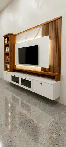 Modern wall-mounted entertainment unit with wooden slats and white storage