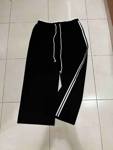 Black relaxed track pants with white side stripes and drawstring — size XL
