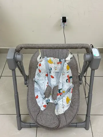 Gently used electric baby swing/rocker with harness and toy bar