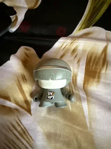Small collectible vinyl toy figure - grey astronaut/robot