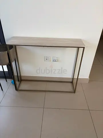Slim console table with metal frame and light wood top — good condition