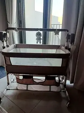 Used bedside bassinet / cradle with storage and wheels - good condition and not used