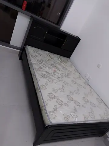 Single wooden bed frame with mattress and headboard