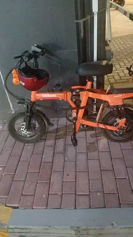Orange folding electric bicycle - compact commuter bike