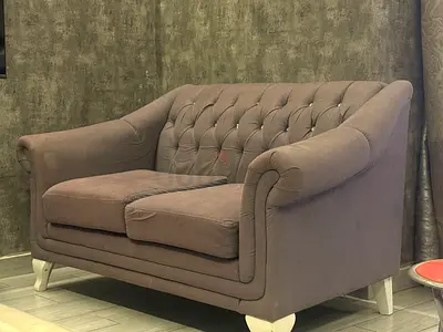 2-seater tufted fabric sofa in good condition