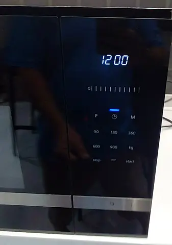 Used built-in microwave oven with digital touch controls - good condition