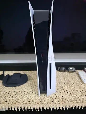 og PS5 disk with stand, controller, cables, and games.