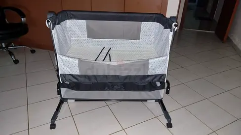 Portable bedside crib in grey — good condition