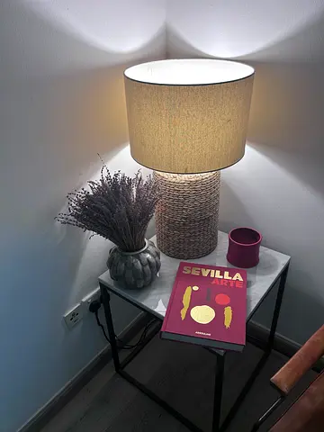 Bedside table lamp with woven base on small side table