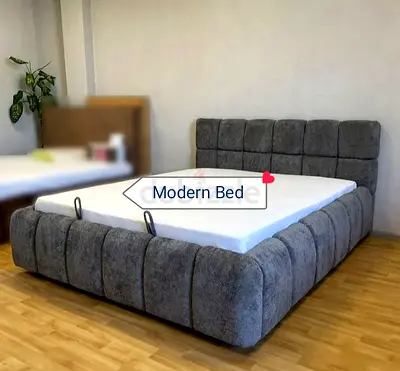 Grey upholstered modern King size bed with padded headboard