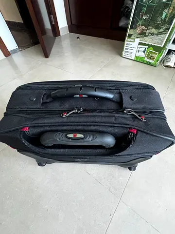 Black soft-shell computer carry-on suitcase with wheels and telescopic handle