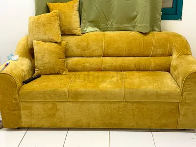 Three-seater mustard yellow sofa in good condition