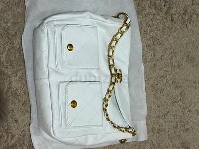 White quilted shoulder bag with gold chain handle