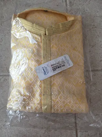 New traditional men's kurta / thobe in gold with white pants — still in packaging