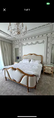 Vintage-style carved wood king bed with upholstered headboard and footboard and mattress only