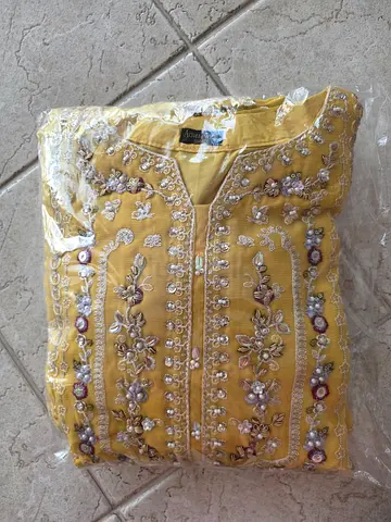 Yellow embroidered women's kurta - new, folded