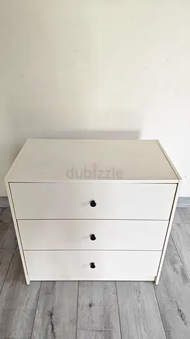For sale: a set of 3 beige 3-drawer chests with black round knobs. Each unit measures 67 cm in heigh