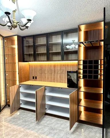 Modern built-in wooden kitchen/bar storage cabinet with glass display and lighting