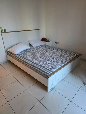 White wooden double bed frame with mattress included